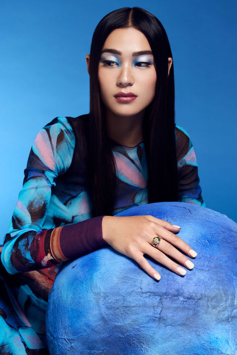 Photographe bijoux Paris, boucle d’oreille dans lumière dorée, ambiance fine joaillerie.