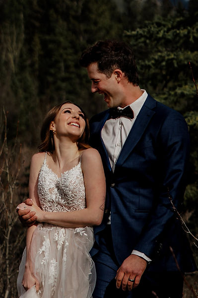 married couple smiling in the forest