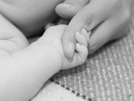 Baby's hand in mother's hand
