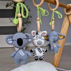 Three hanging toys with crocheted soft animals: koala, zebra, elephant