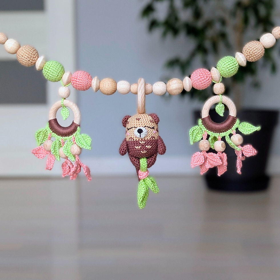 Thumbnail: Handcrafted stroller chain with otter rattle and botanical elements, in pastel colors by ColoredYarn