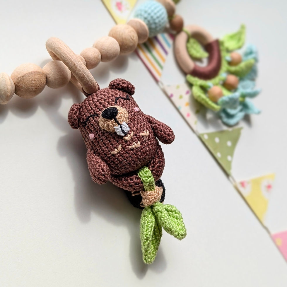 Thumbnail: Crocheted beaver rattle and wooden ring, botanical motifs in brown-green colors for pram garland