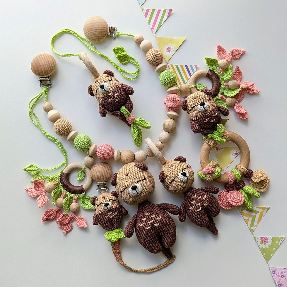 Curious Otter Baby Gift Set featuring 5 handmade toys: pacifier clip, rattle, stuffed doll, hanging toy, and stroller toy