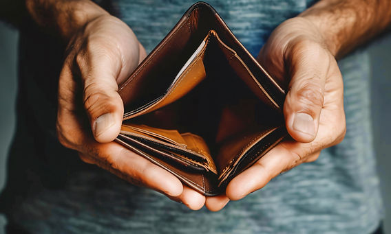 Pensioner holding an empty purse, illustrating financial strain and the importance of early tax planning with support from Money Tax Smart.