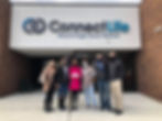 Group outside ConnectLife HQ with check presentation