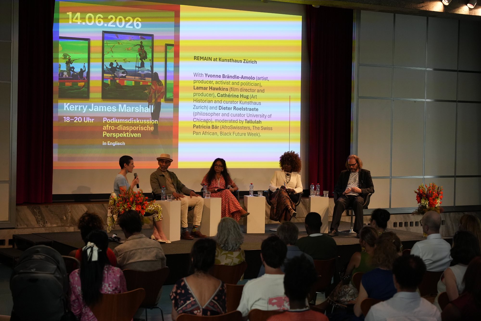 The panel on stage at Kunsthaus Zürich, with the audience in front