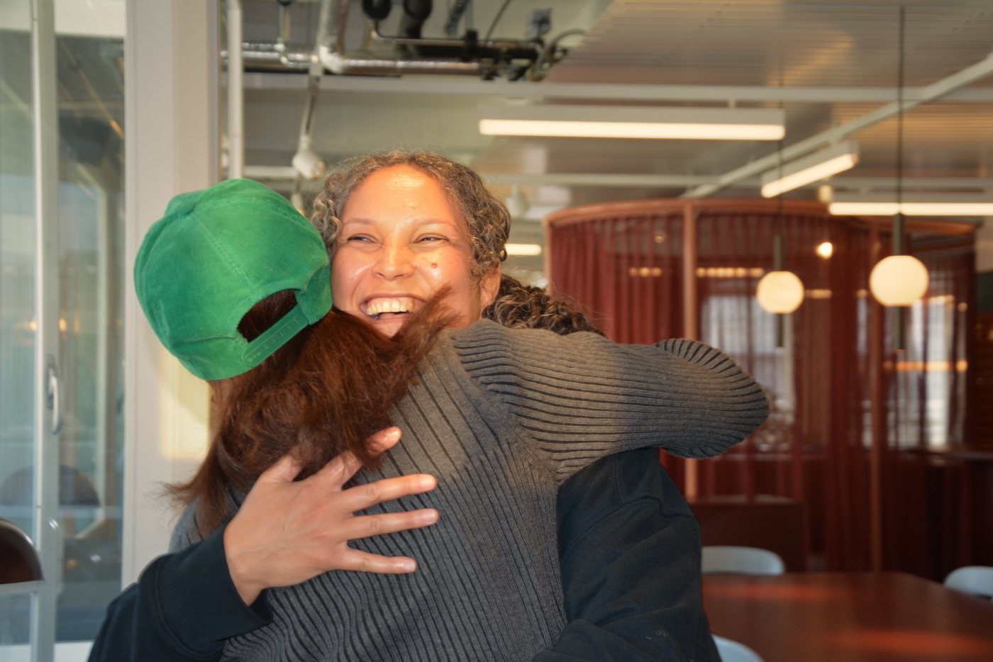 Two guests hugging and laughing at the apéro