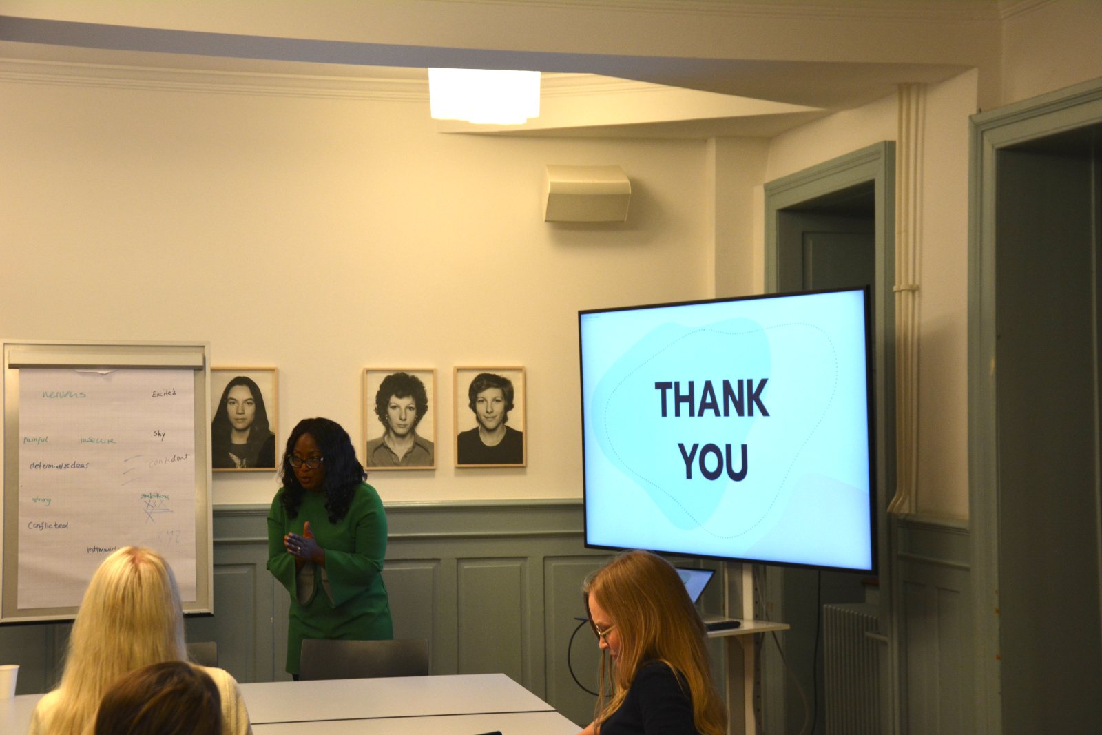 Claudia Bruce Quartey beside a screen that reads Thank you