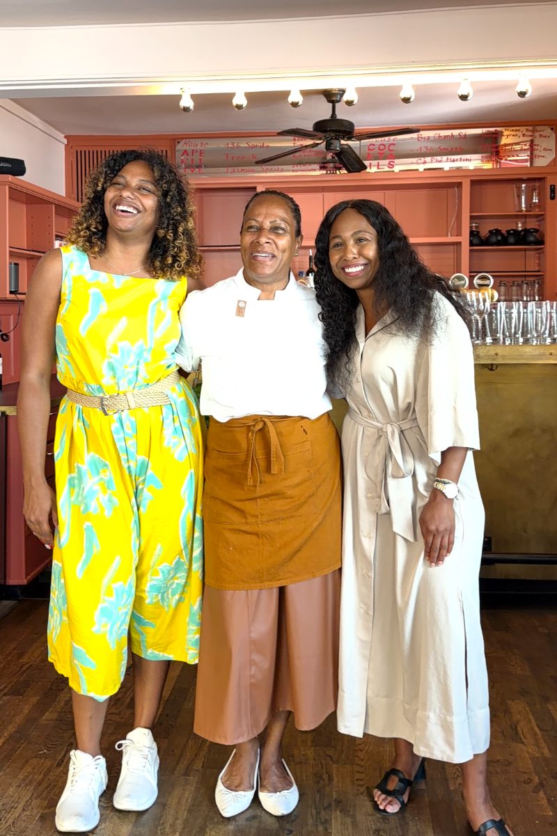 Three women laughing together at the bar