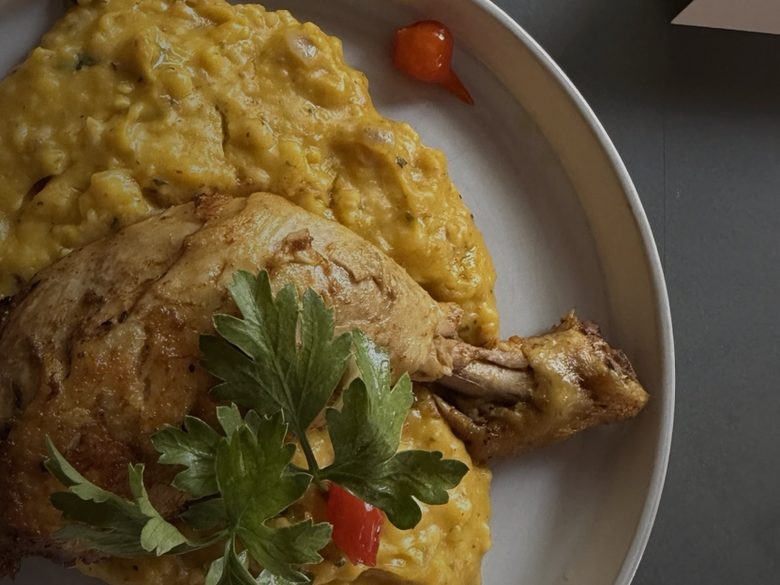 Chicken with a golden purée, garnished with parsley