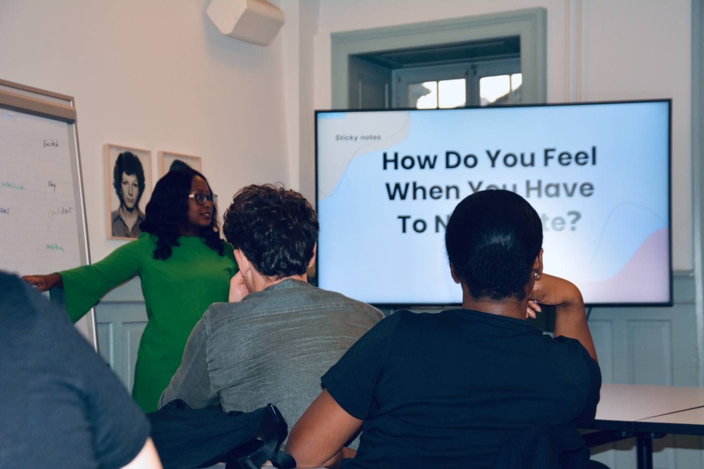 Claudia Bruce Quartey points to the flipchart; the screen asks How do you feel when you have to negotiate?