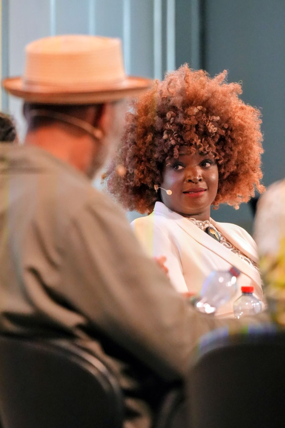 A speaker listening on stage