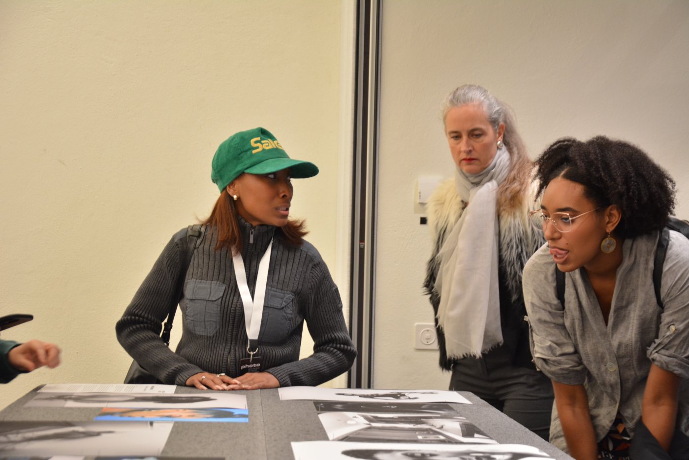 Kourtney Iman King at the print table with two visitors