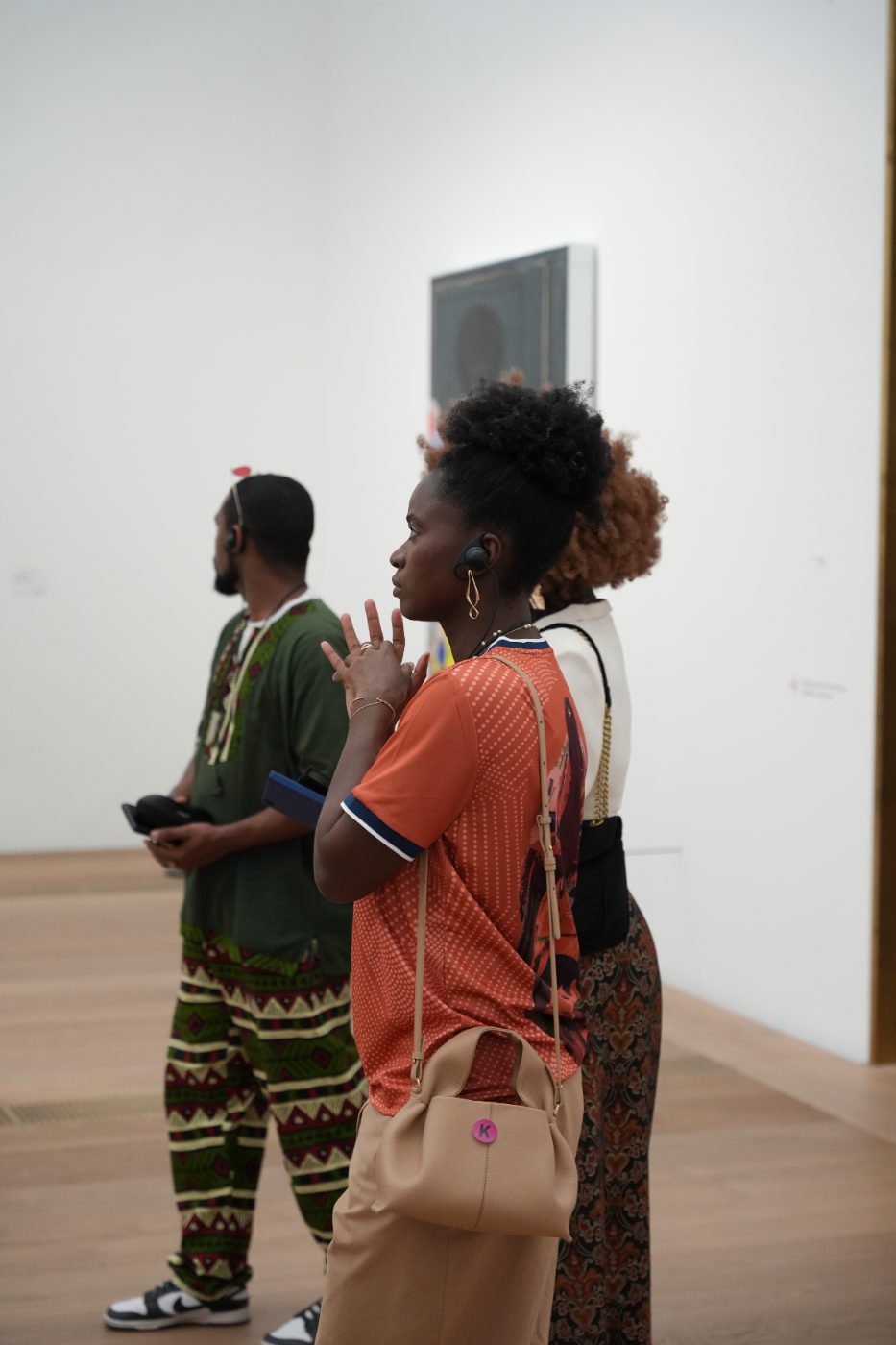 A guest with an audio guide listening during the tour