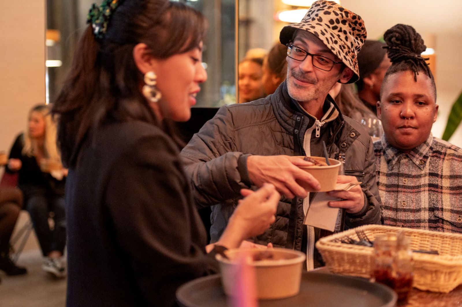 A guest being handed food in a bowl