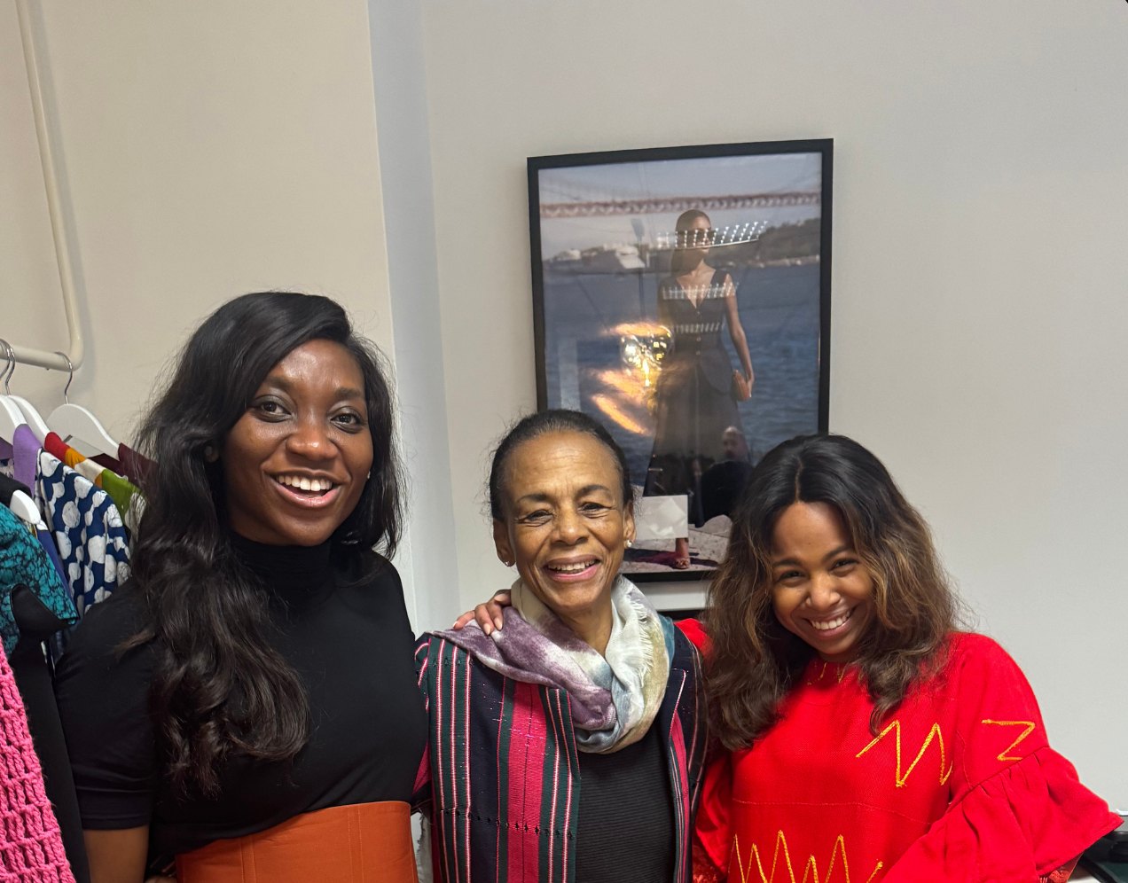 Three women smiling side by side