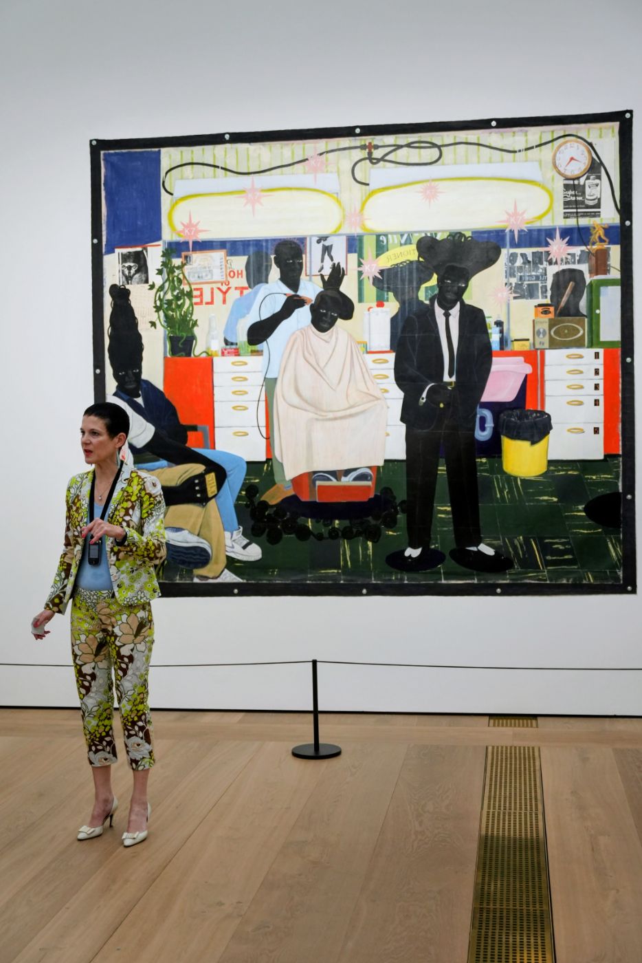 The guide in front of a large painting of a barbershop