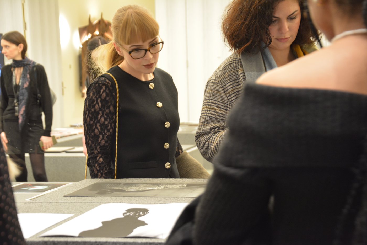 Visitors looking at photographic prints