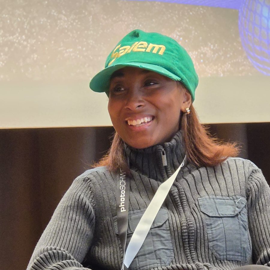 Kourtney Iman King in a green cap, smiling