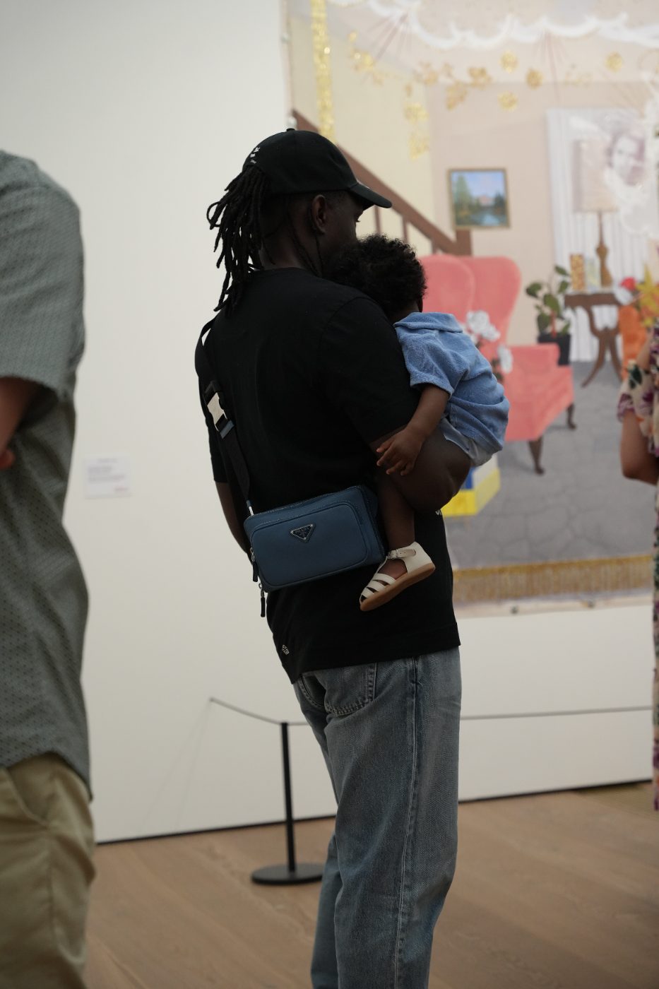 A father carrying his child through the exhibition