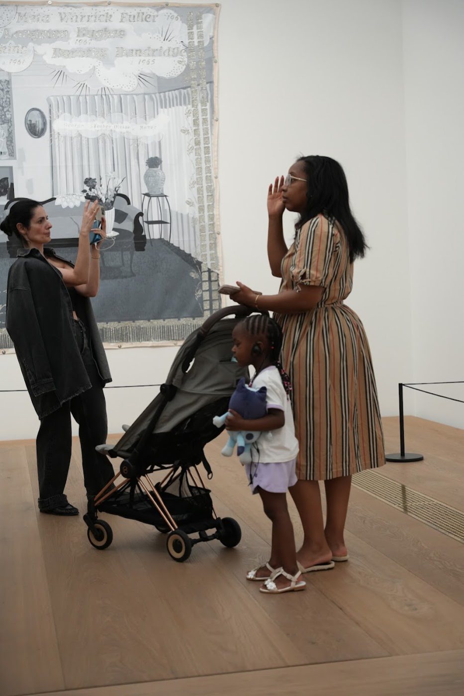 A mother with her daughter and a stroller in the exhibition