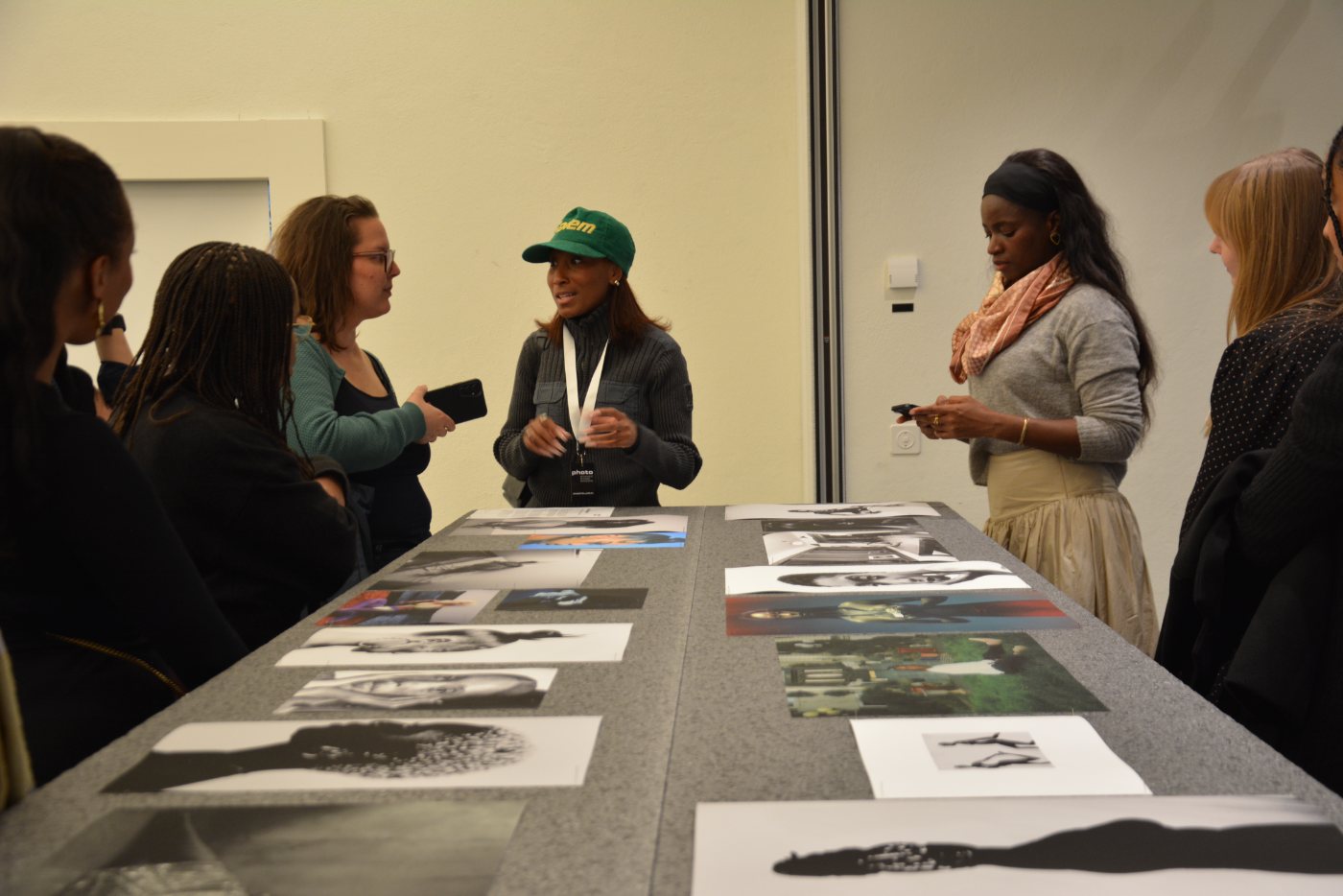 Kourtney Iman King at the print table, surrounded by visitors