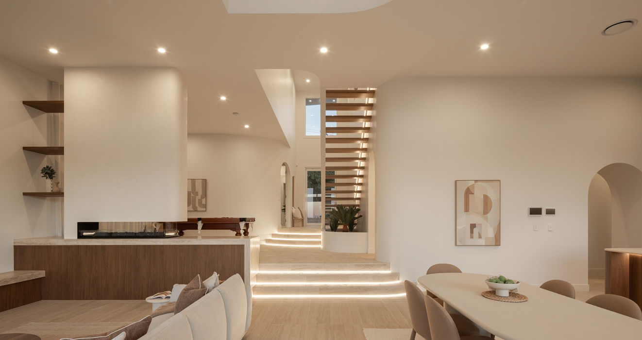 Living and dining looking toward the open timber staircase and void at Sierra, a luxury residential home by Sabdia in Holland Park West, Brisbane.