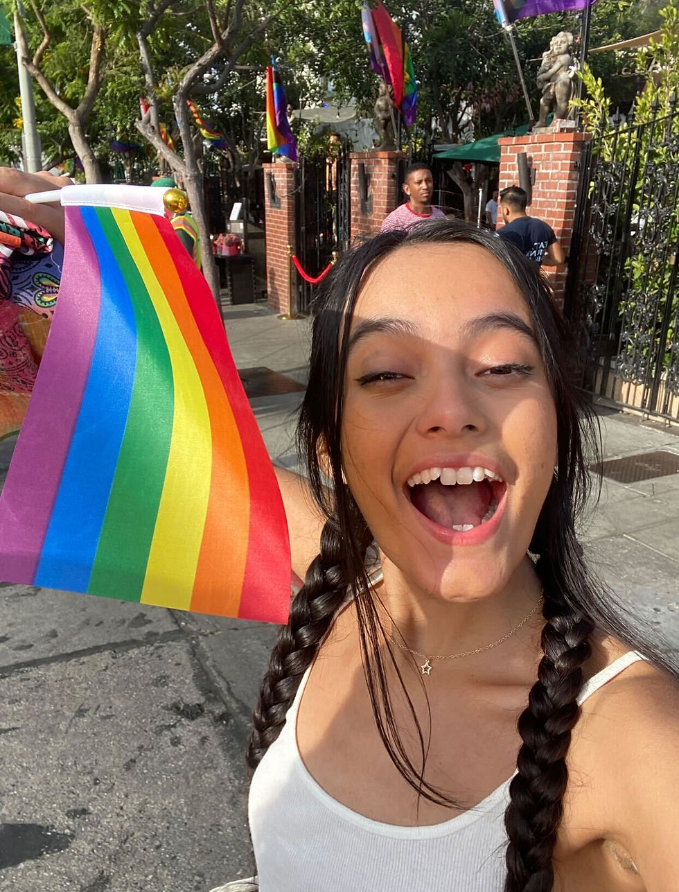 Desiree holding a pride flag