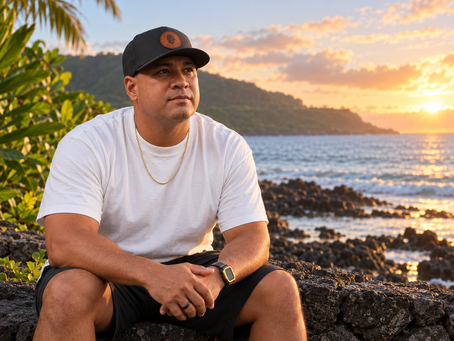 AI-generated depiction of Mike Garcia seated on a rocky Hawaiian shoreline at sunset.
