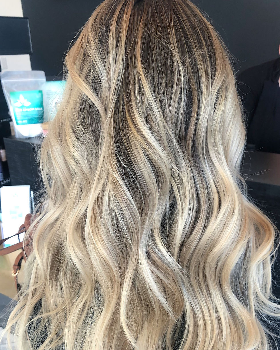 Lived-in blonde balayage hair color with dimensional highlights in Fort Myers Florida