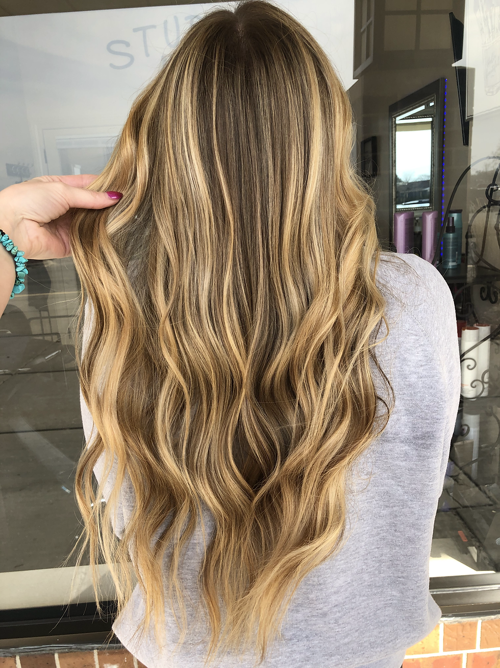 Lived-in blonde balayage hair color with dimensional highlights in Fort Myers Florida