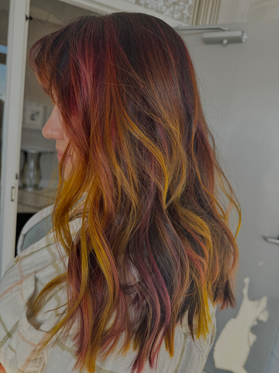 Vibrant fashion hair color with pink purple and blue tones by Fort Myers color specialist