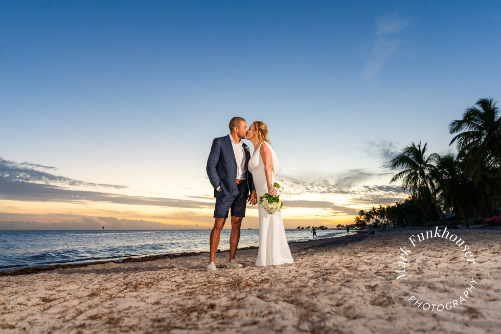 Key West wedding photography of a couple kissing on the beach during sunset after getting married