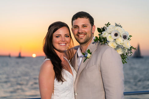 After getting married on Party Cat, this Sunset Watersports wedding couple is having sunset photos taken during their dinner cruise