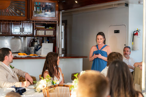 A bridesmaid gives a speech during a wedding dinner