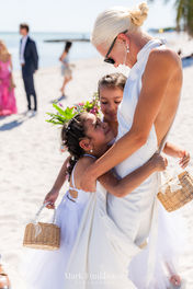 Flower bearers hug the bride at Smathers Beach
