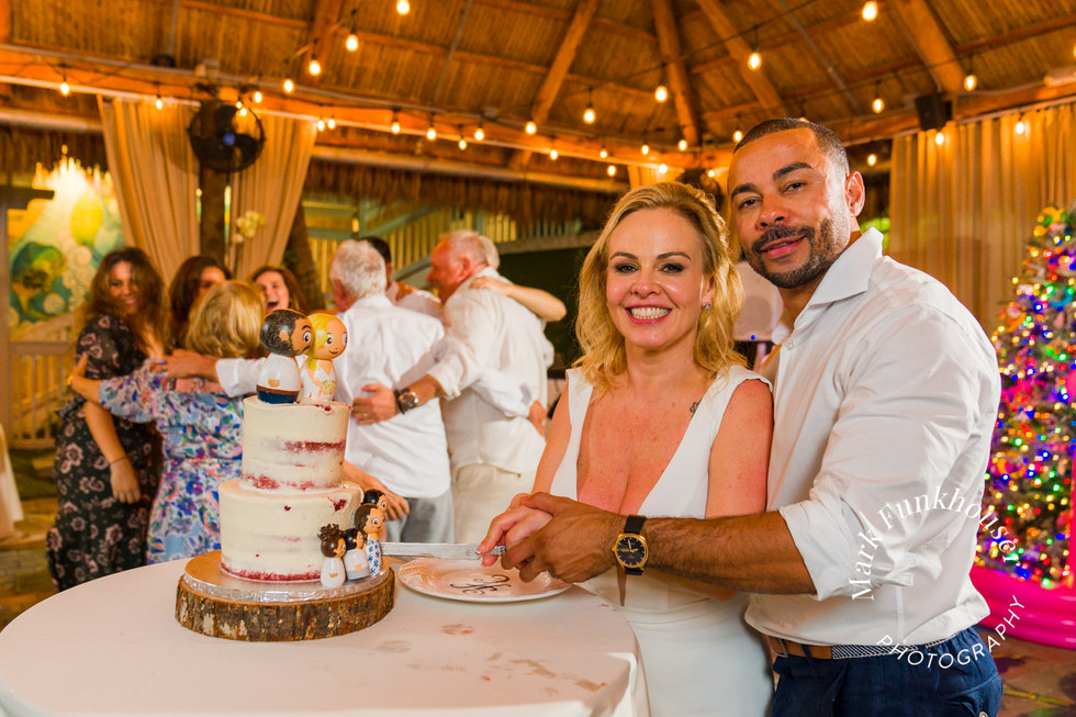 A Key West wedding couple cutting their cake during their wedding reception