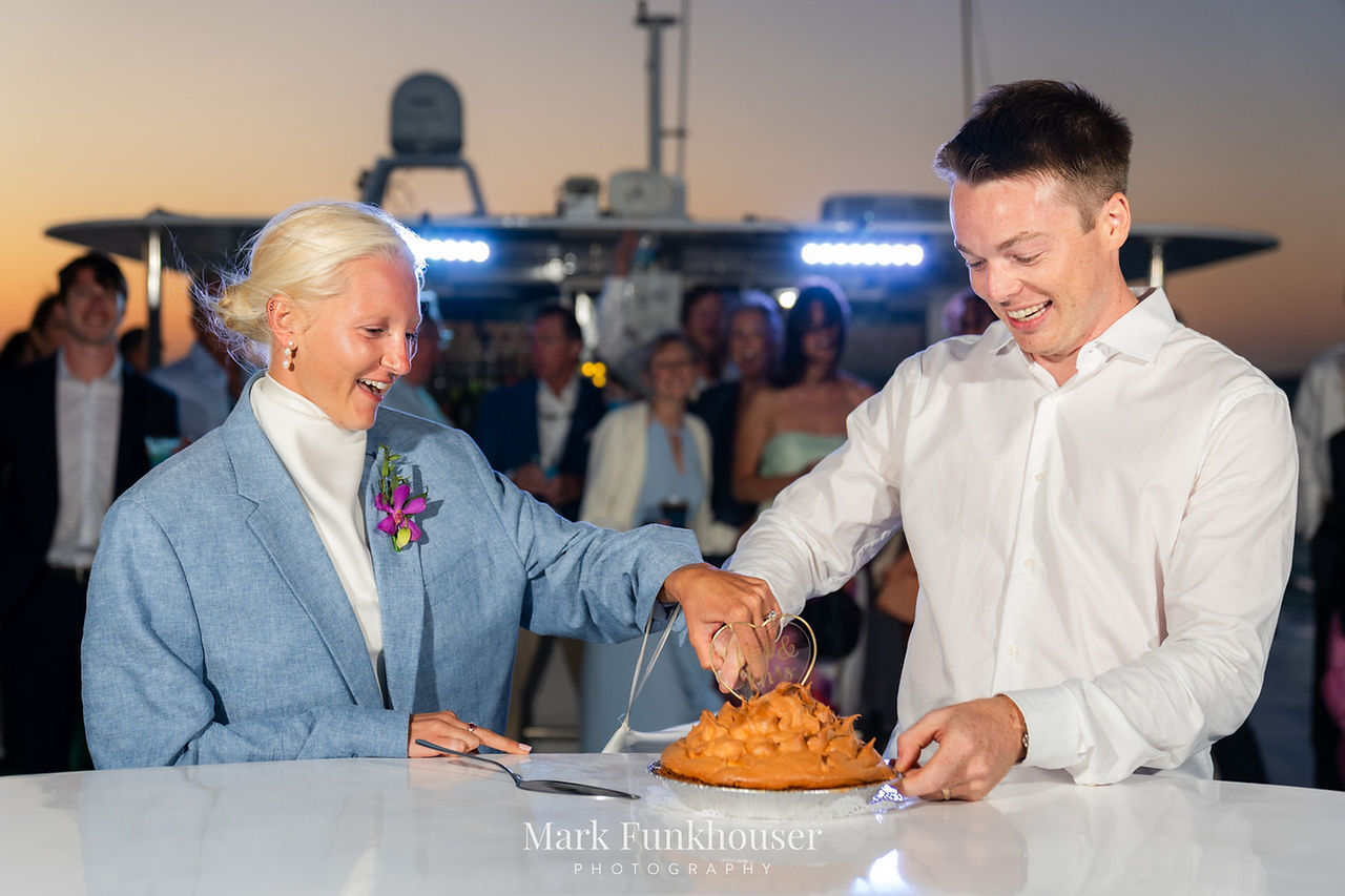 A bride and groom cut their wedding cake 
