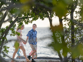 Candid surprise proposal photography being taken by an undercover photographer.