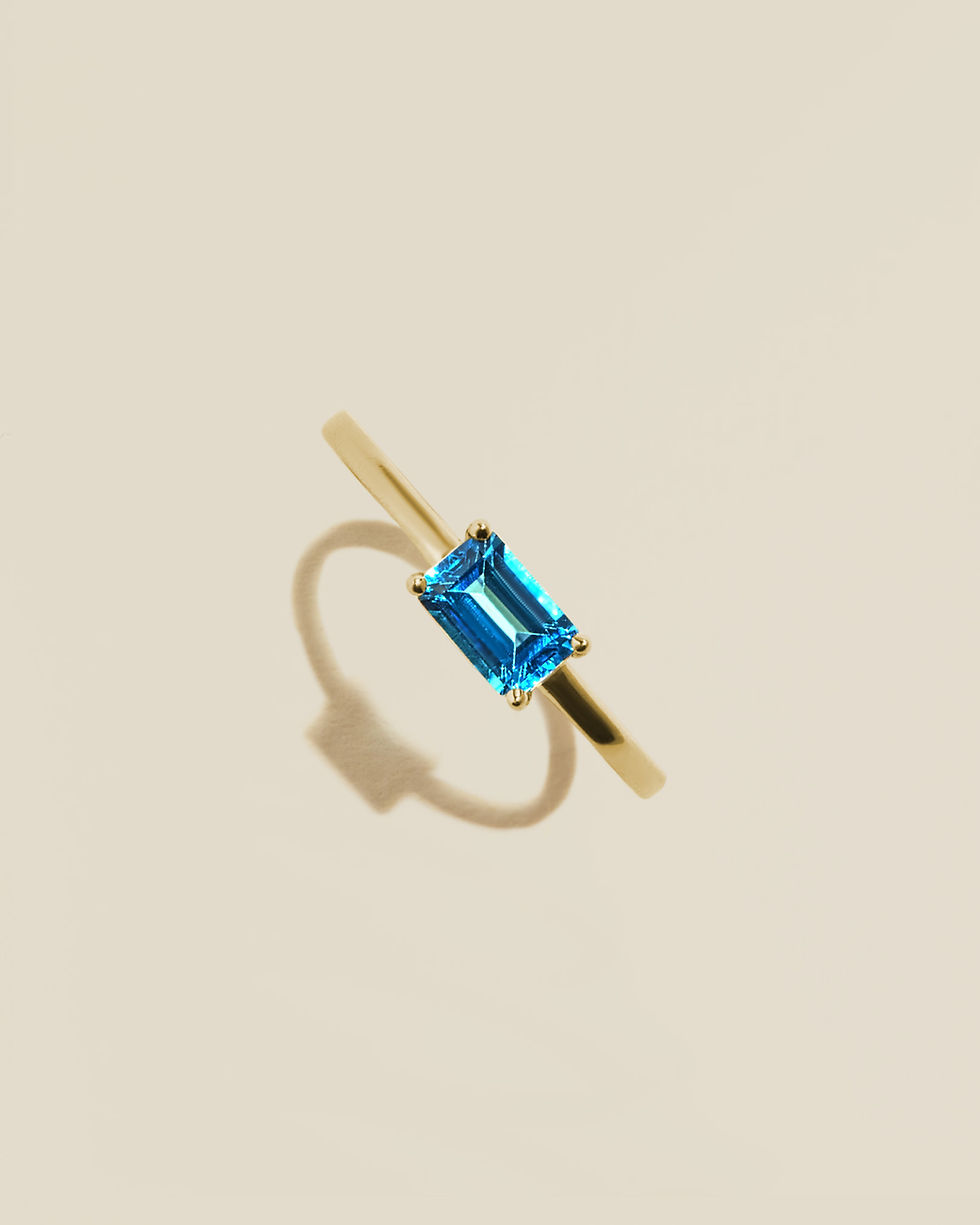 Thumbnail: Yellow Gold Ring featuring a blue topaz gemstone