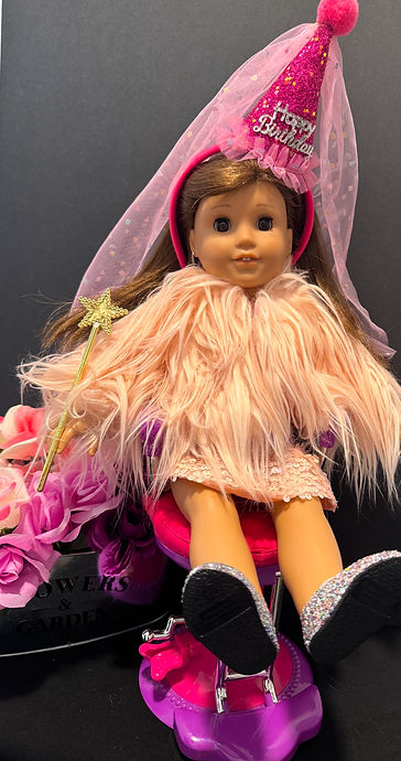 A doll with a birthday hat in a hair salon chair