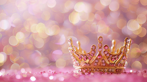 A gold crown with pink gems