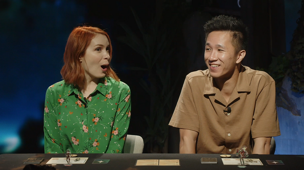 Felicia Day looks shocked, while Brandon Chen gives a nervous smile