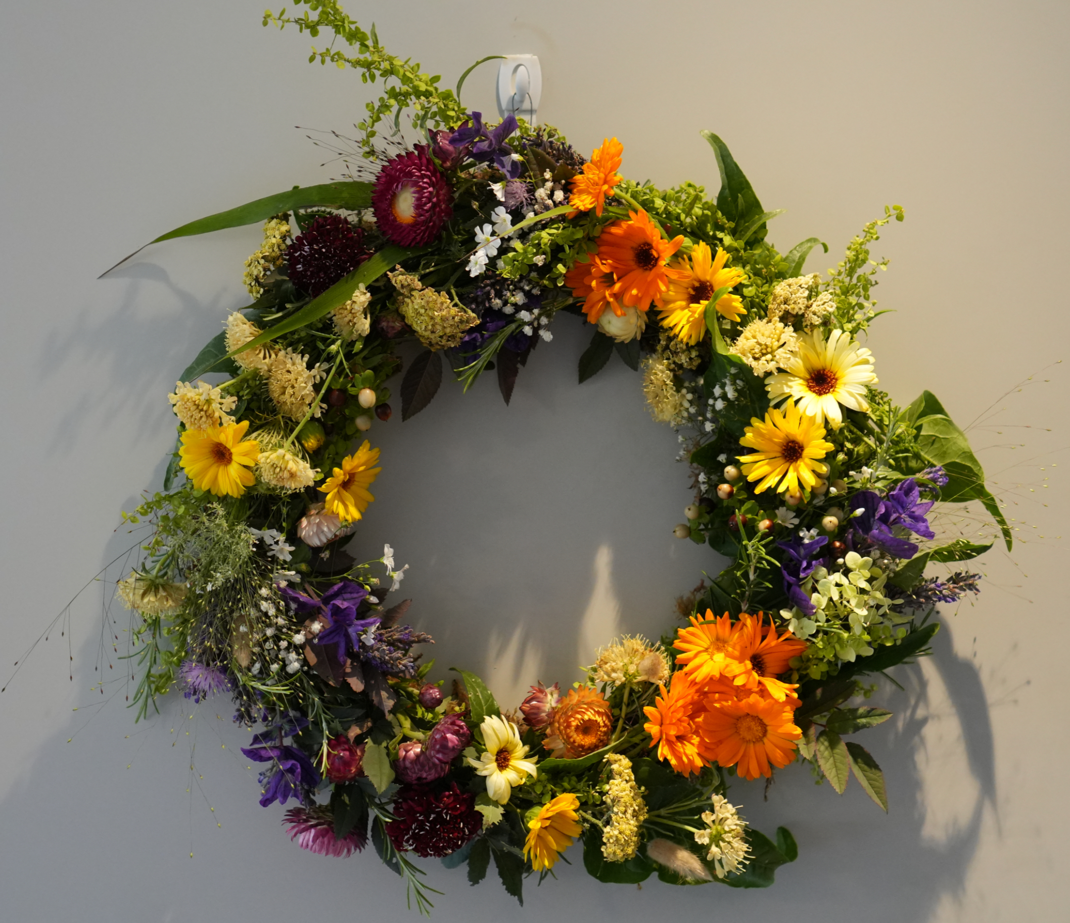 A close-up of a bright, fresh flower wreath with vibrant colours