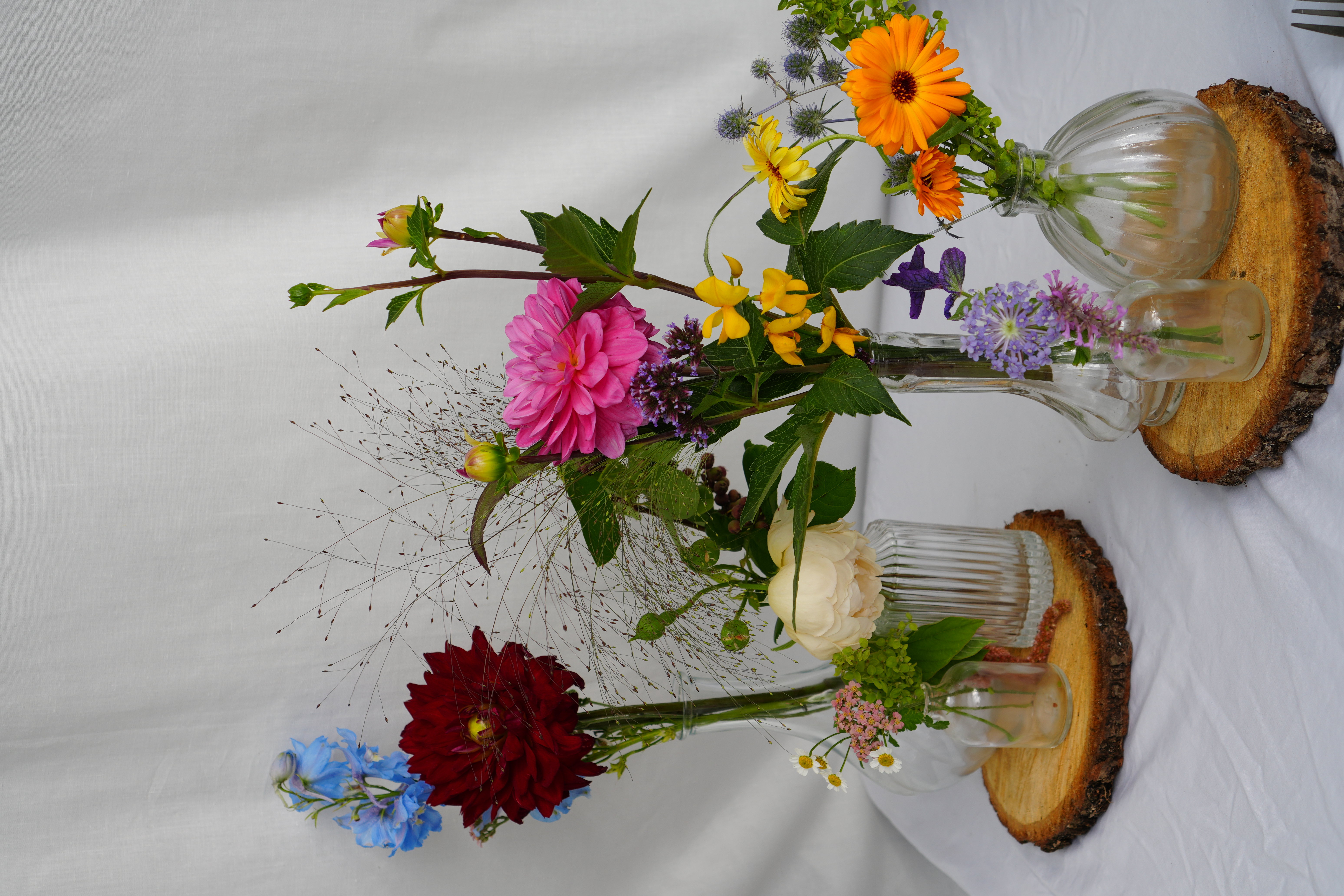 Elegant wedding table decoration with flowers in small bud vases