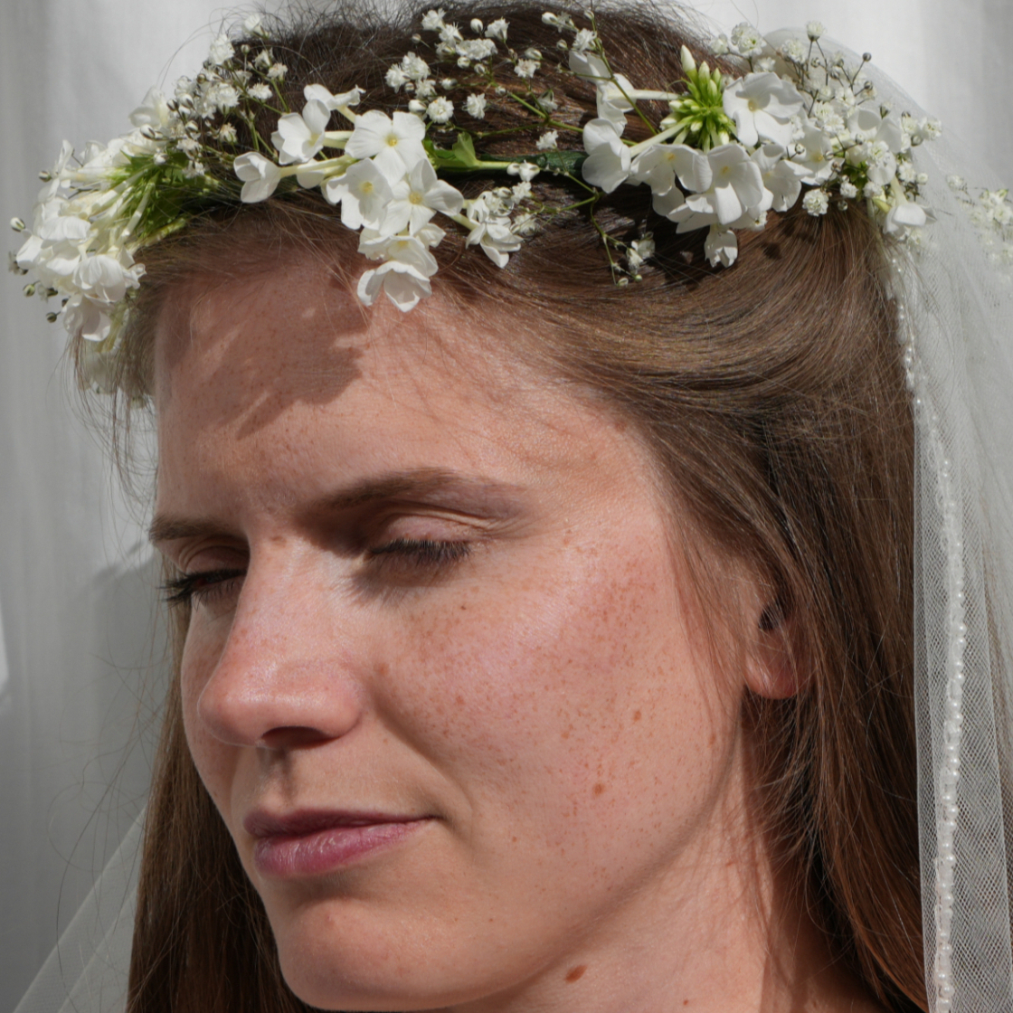 A delicate and dainty white flower crown for a bride