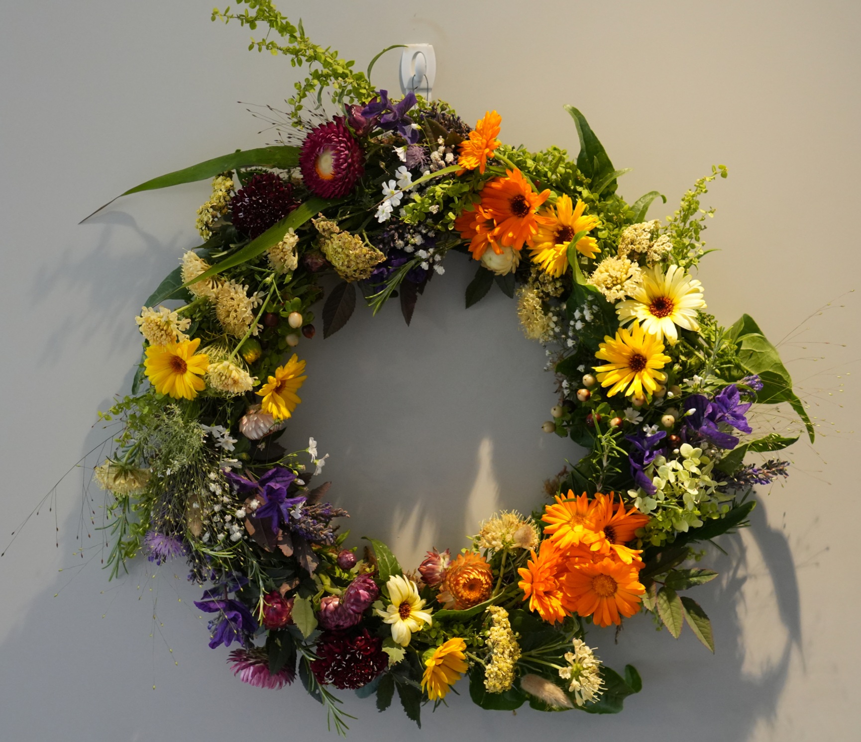 A close-up of a bright, fresh flower wreath with vibrant colours