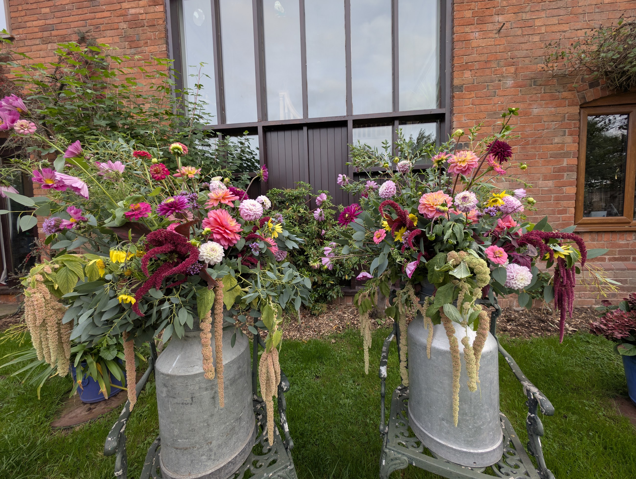 Wedding flowers in milk churns