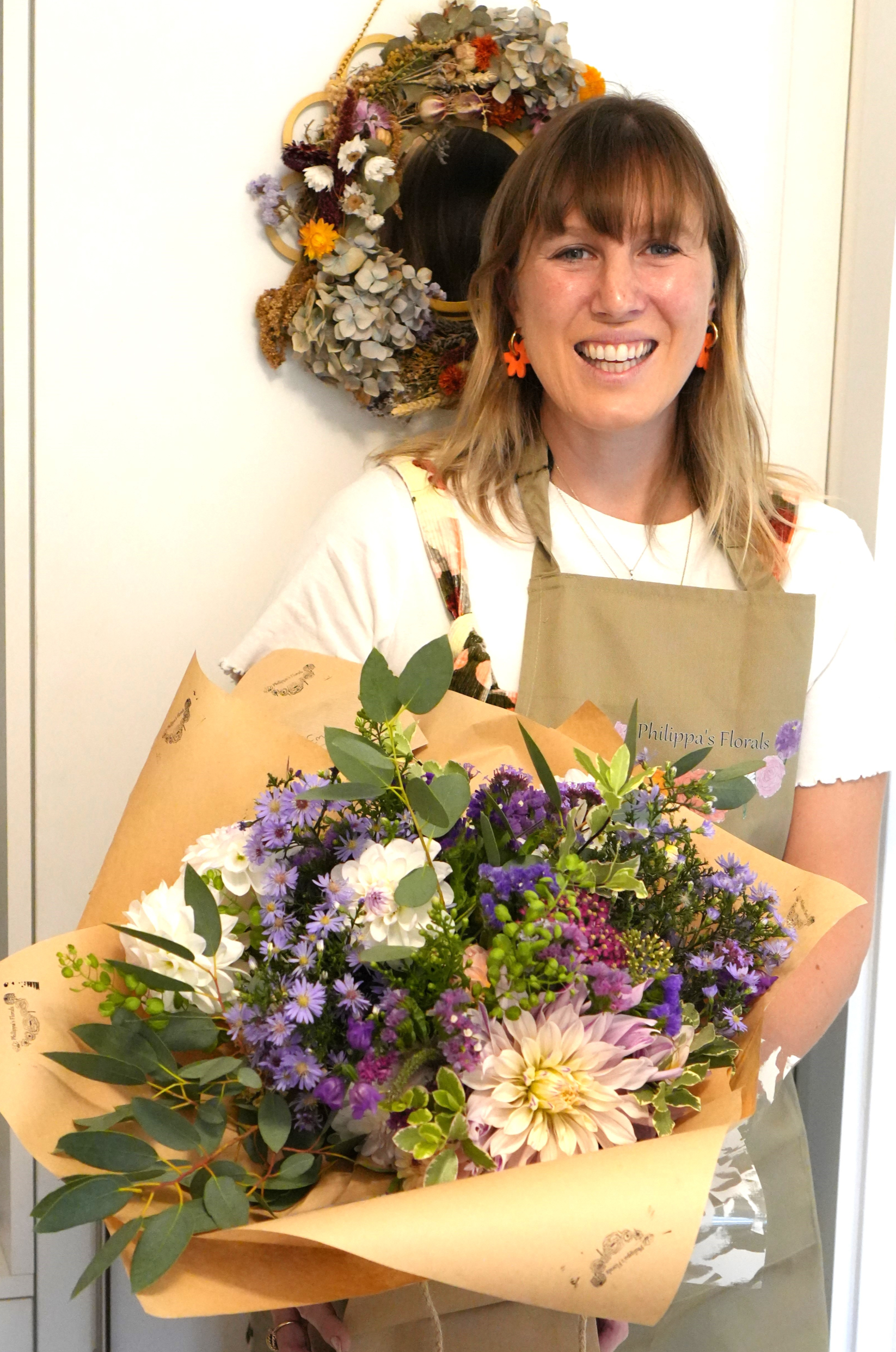 Philippa with gifting bouquet showcasing Philippa's Florals