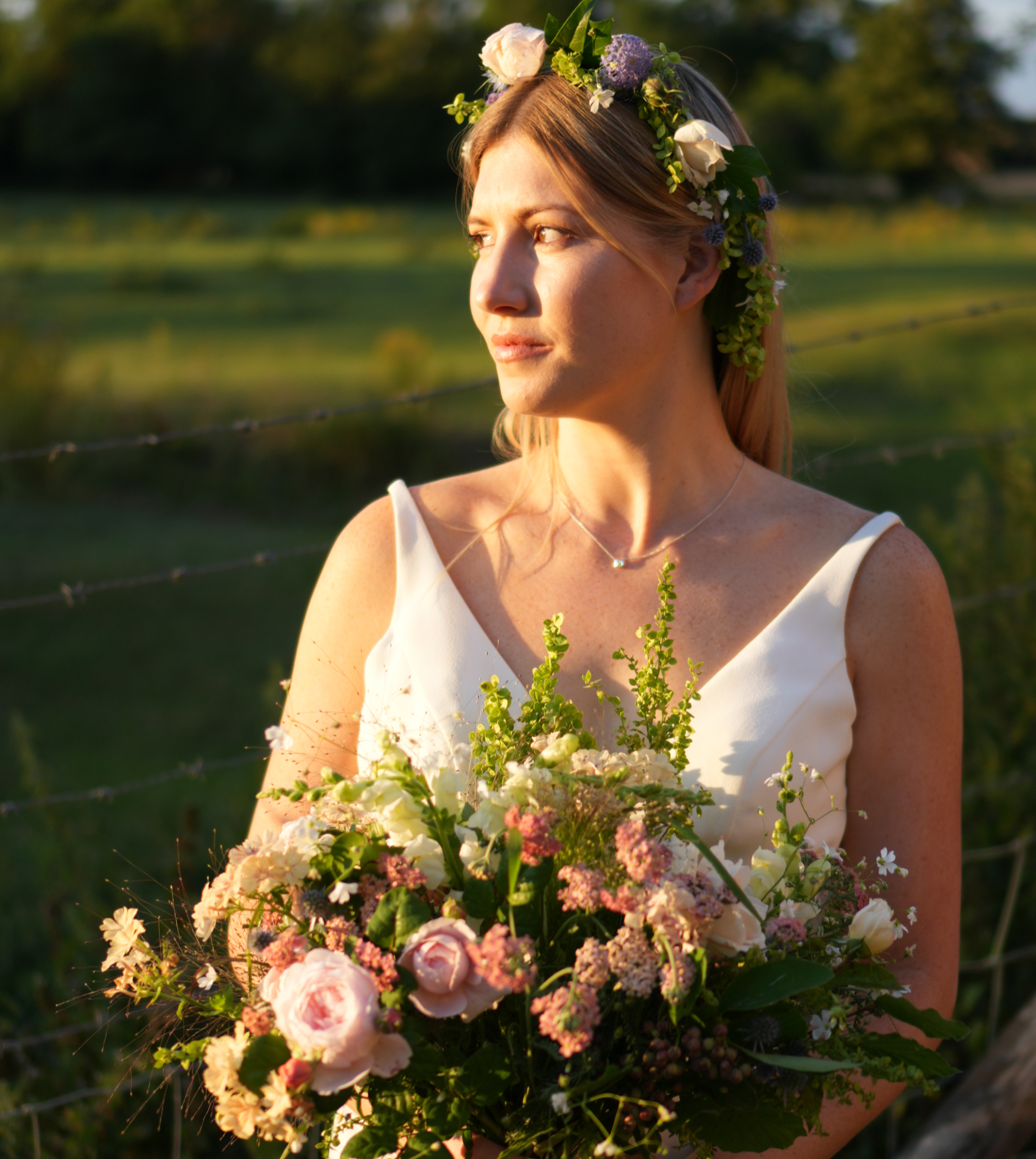 Side profile of a woman holding a large pink floral bouquet